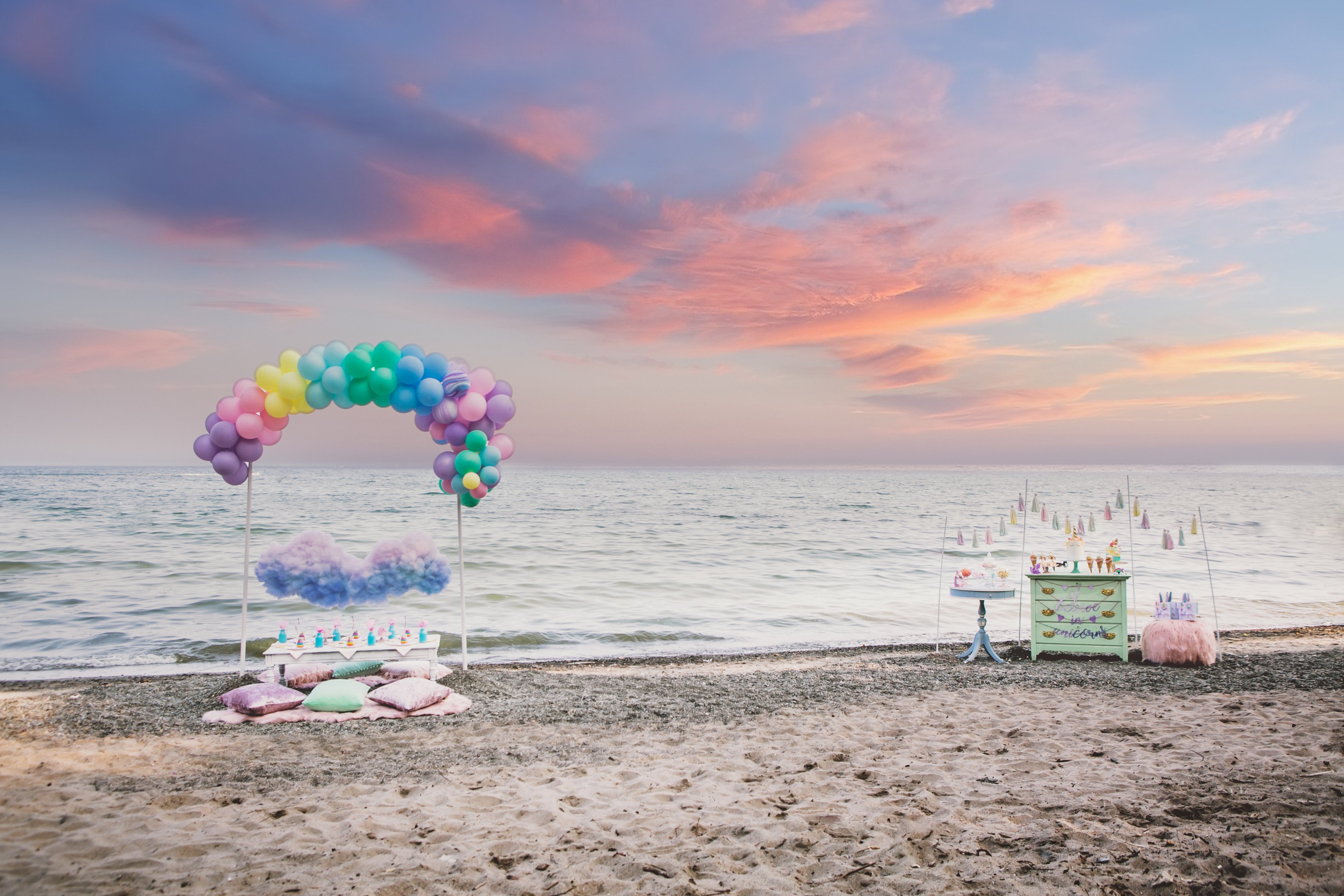 A unicorn and rainbows themed kids birthday party on the beach