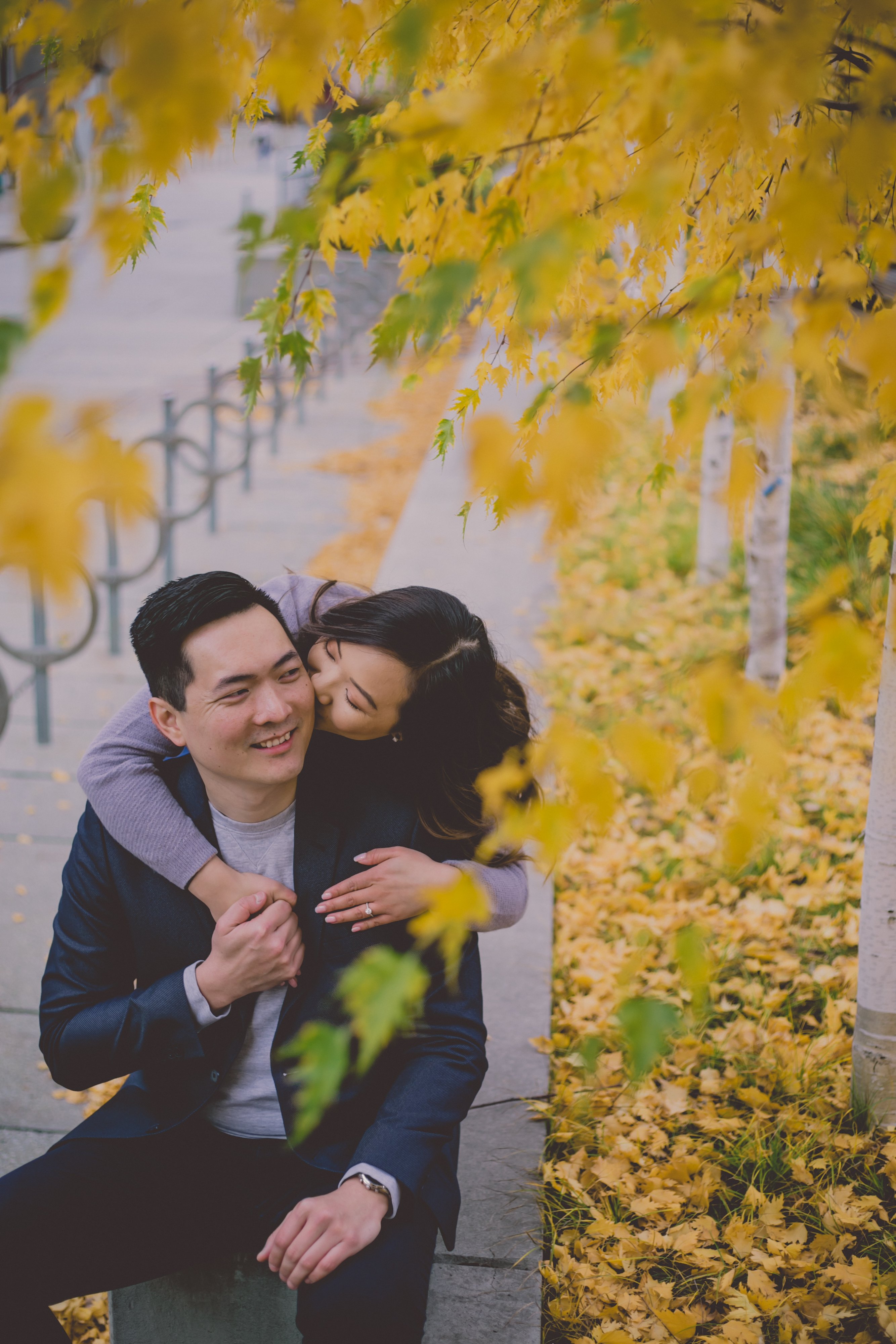 Cute engaged couple kissing at Osgoode Hall, yellow autumn leaves, nature and architecture, Toronto nature and architecture
