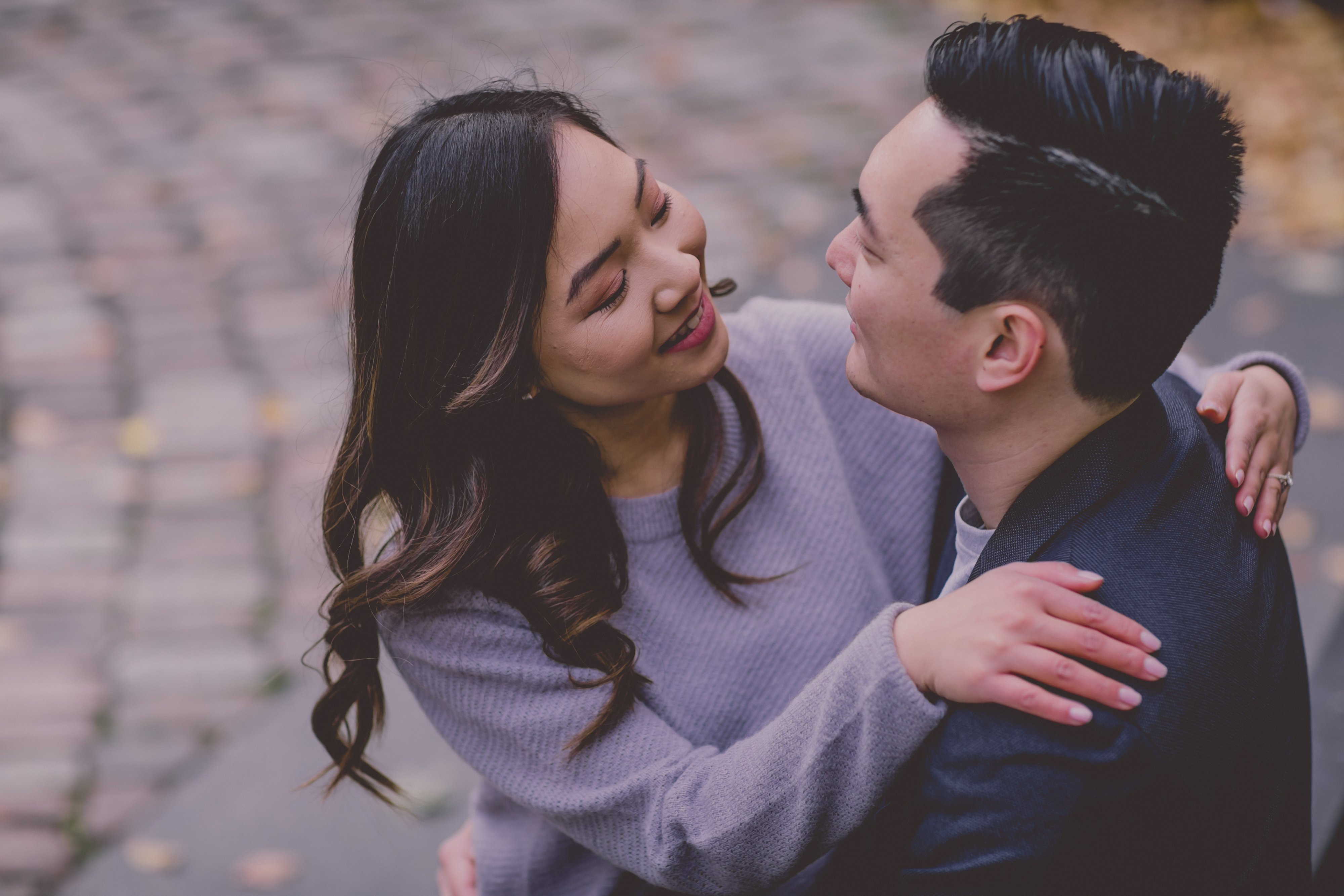 Engagement Photography session in downtown Toronto, photographed by Olive Studio Photography, with Liane and Victor hugging. 