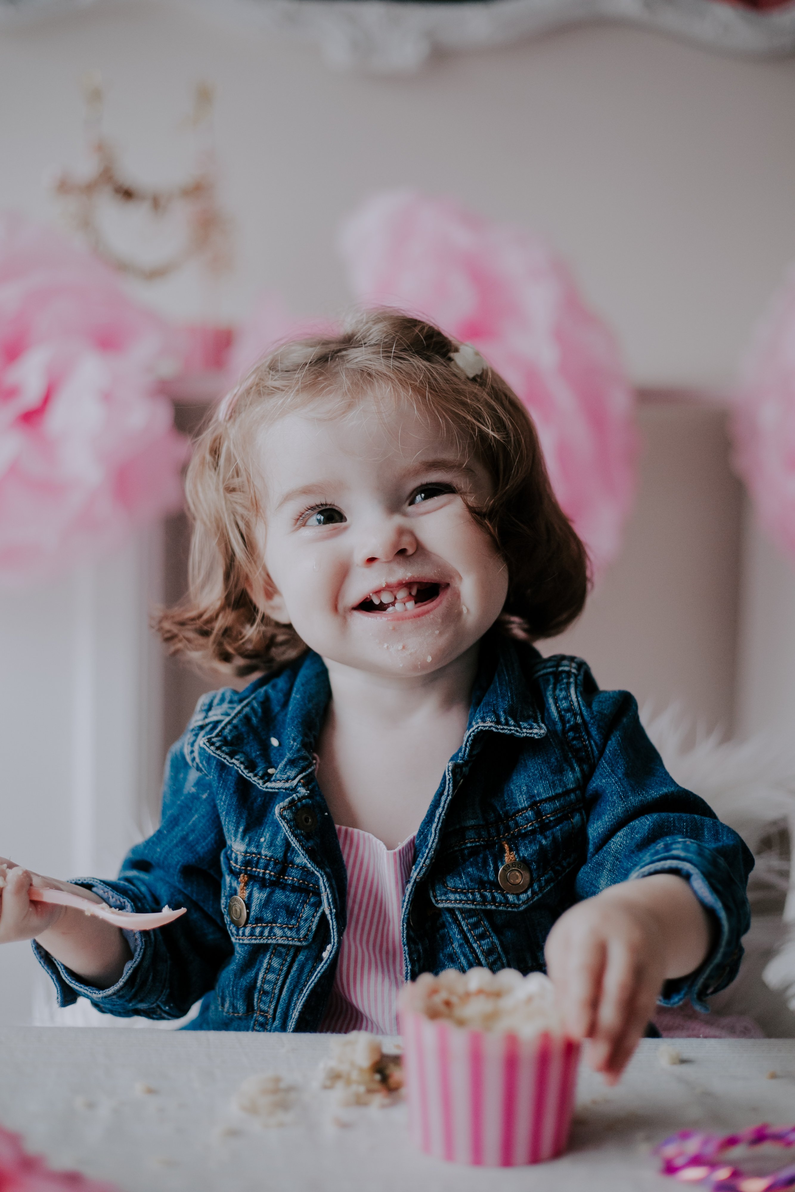Cutest baby smirk from 1-year-old at her Cake Smash Session in Toronto; photographed by Olive Studio Photography.