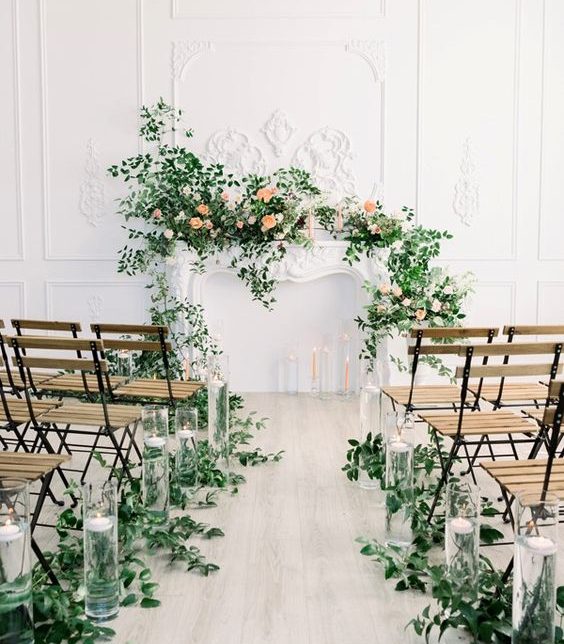 fireplace mantle ceremony backdrop with crawling flowers and foliage