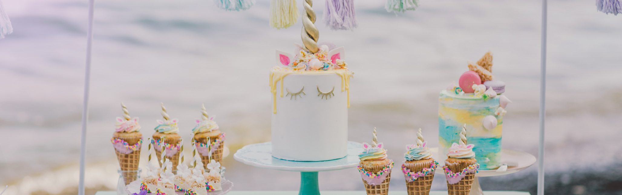 unicorn cake and desserts on green dresser