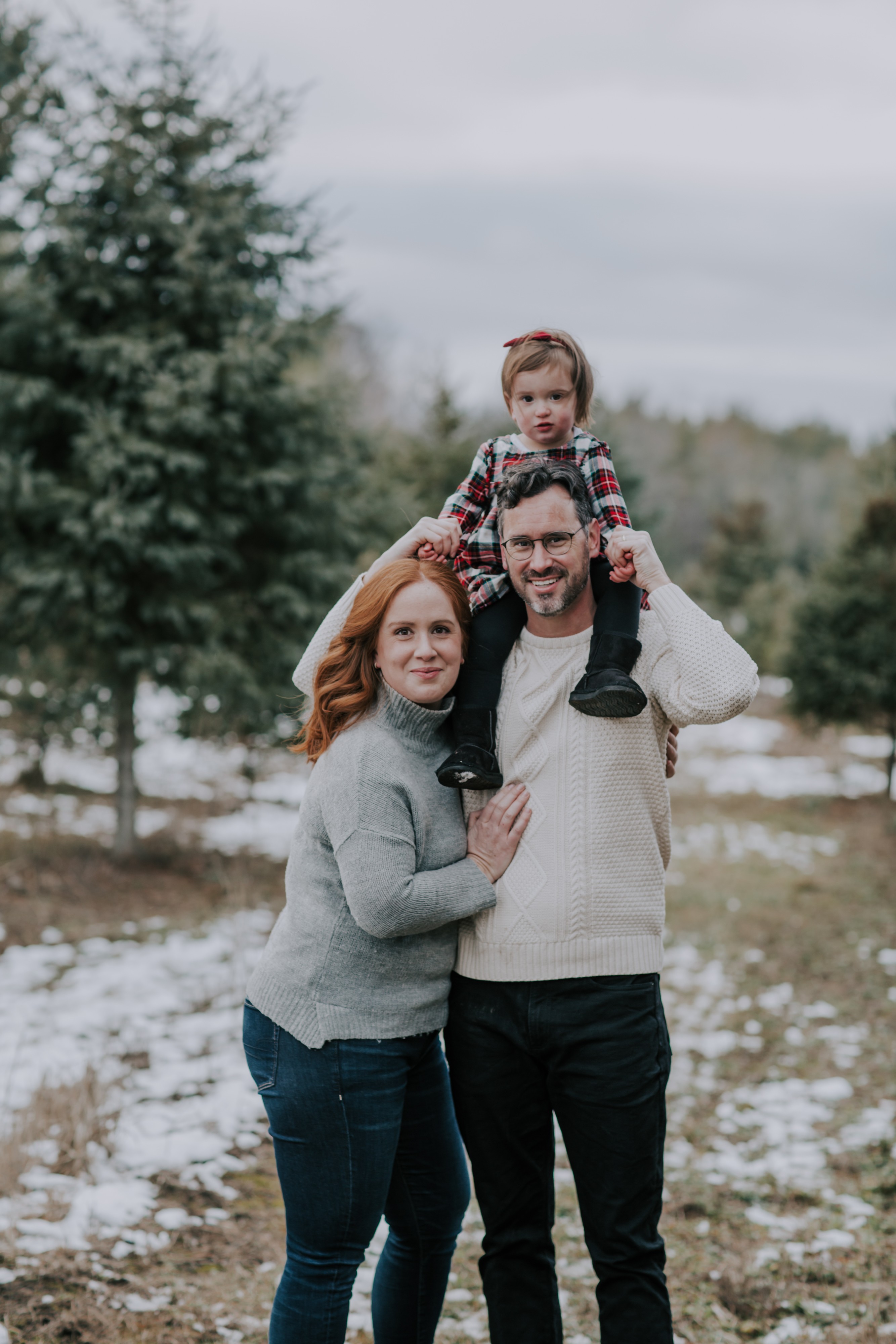 a winter xmas tree shoot with a young couple and toddler daughter