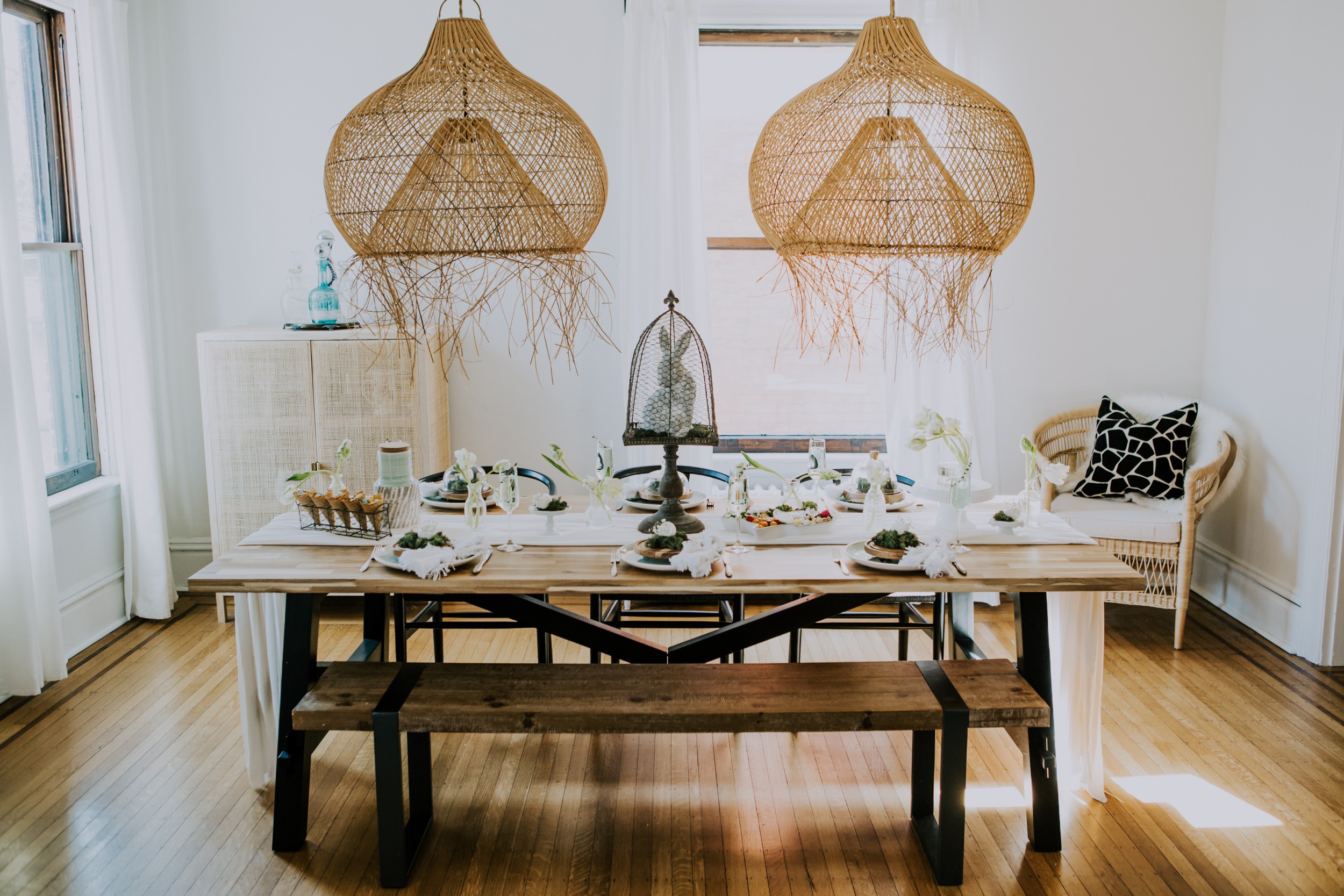 A wooden boho dining room with an Easter tablescape set-up. 