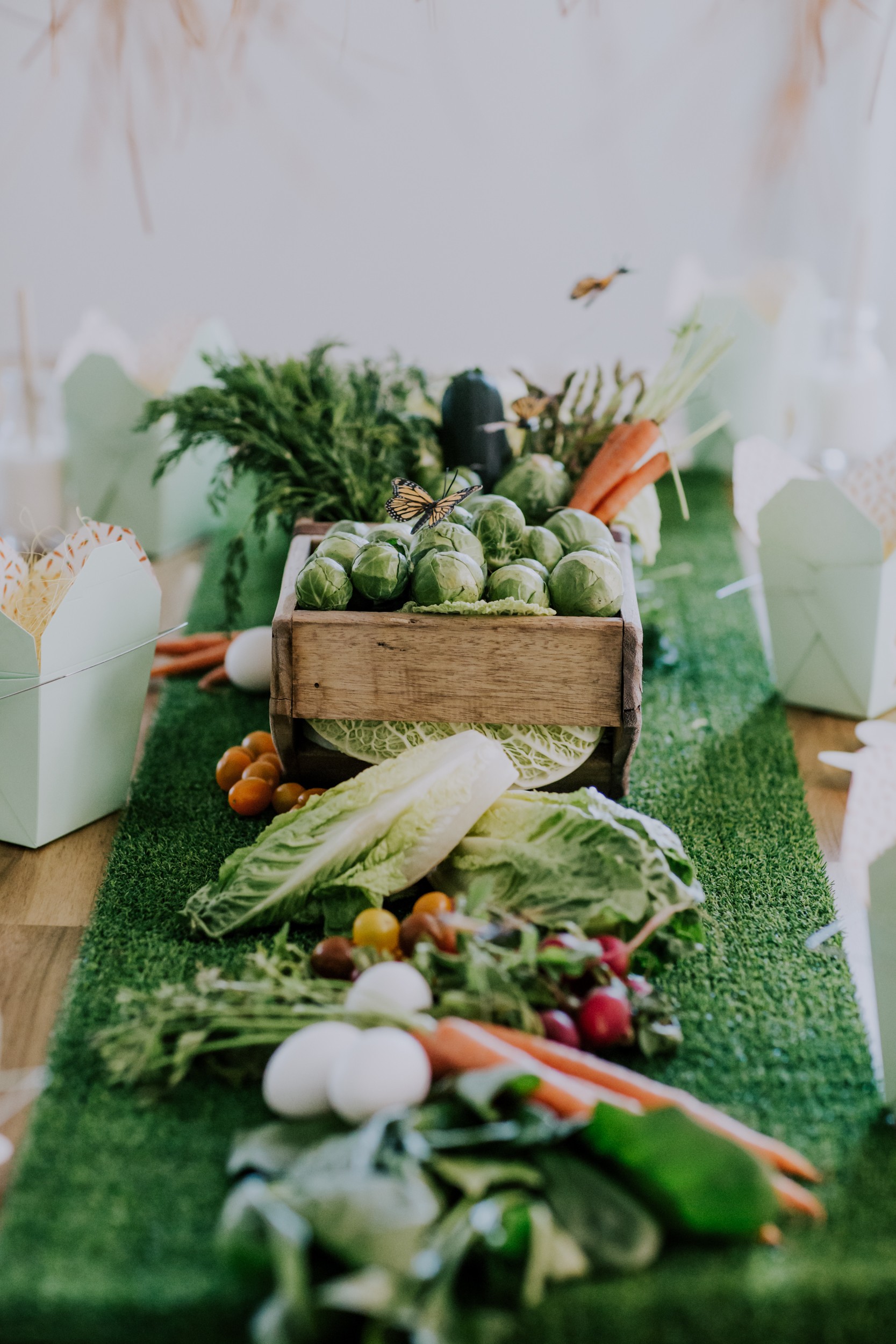 a table runner made out of veggies sports as the main focal point on this table