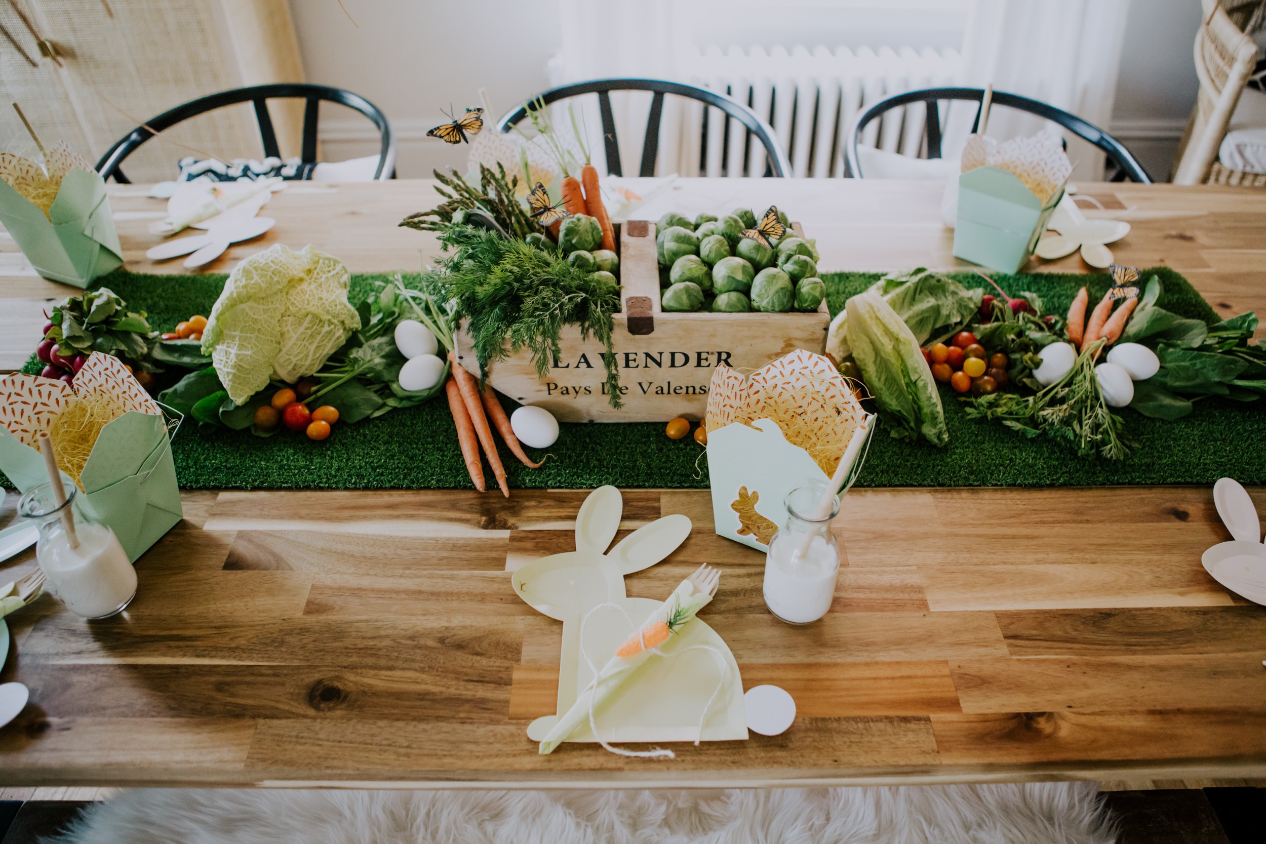 a bunny garden tablescape hosts a vegetable runner and bunny plates