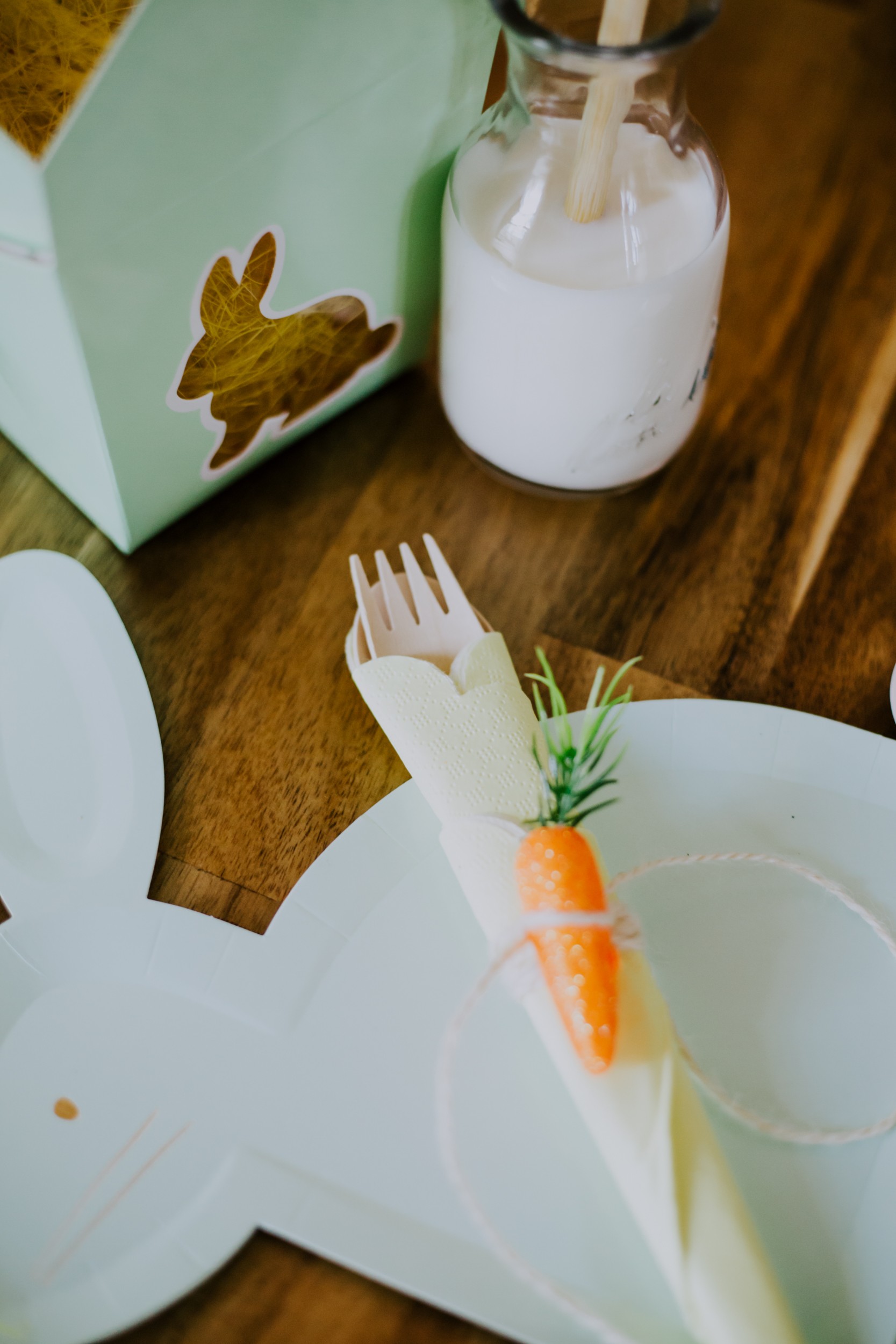 a cutlery rollup features a tiny carrot as decor