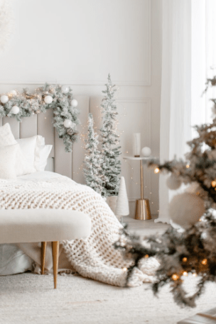 bed and christmas tree in white and green